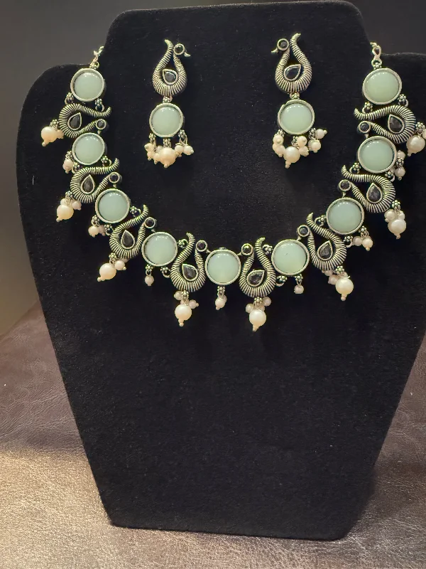 Amazing Sky Blue Stone Studded Peacock Design Silver Plated Oxidized Necklace Set With Earrings And Pearl Beads