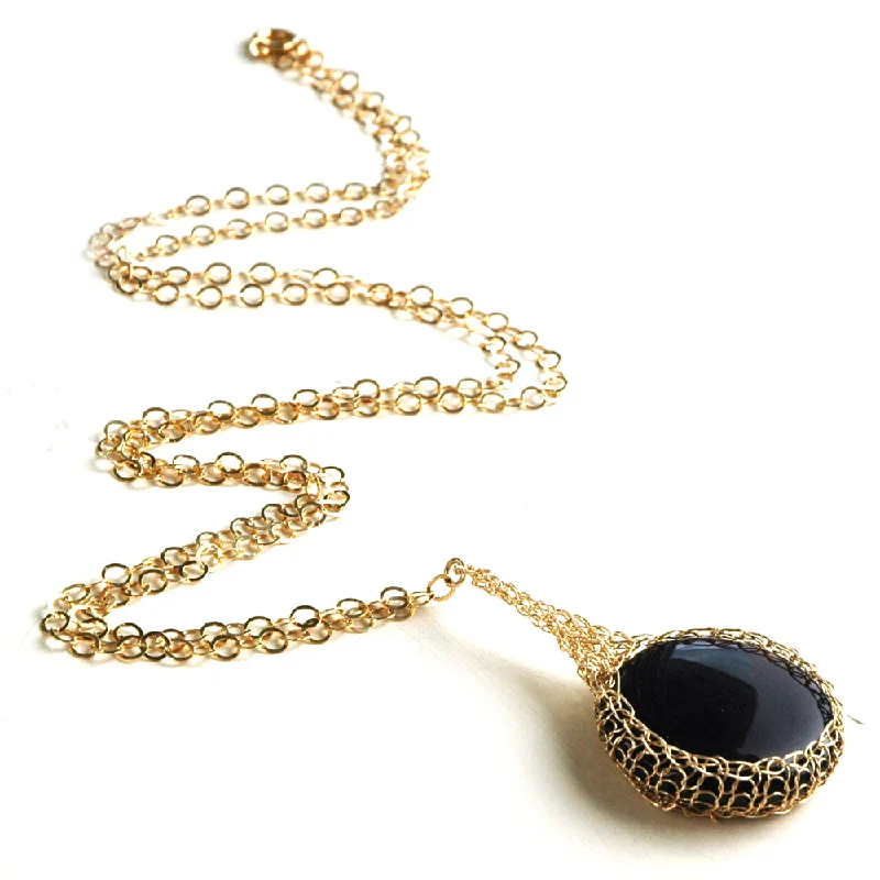 Black Onyx  pendant necklace, nested in gold wire crochet