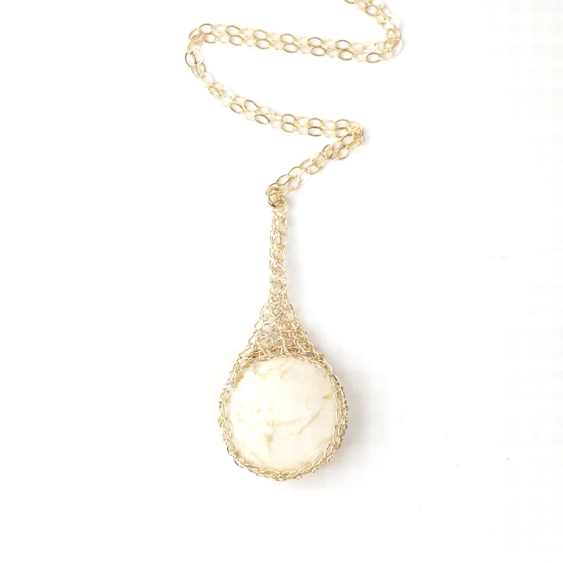 Round IVORY Howlite pendant necklace, nested in gold wire crochet